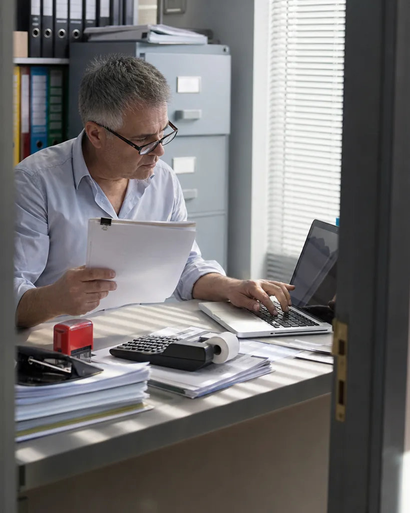 Finance manager approving a reconciliation on a laptop